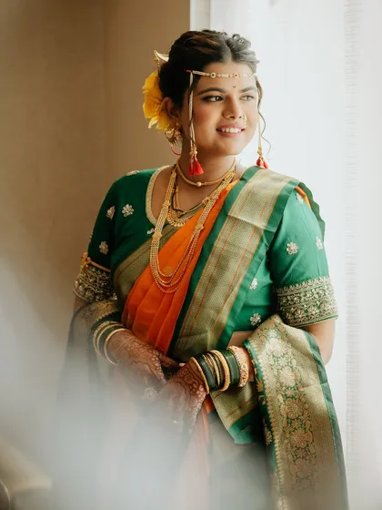 A soft, dreamy portrait of our Maharashtrian bride. The natural light highlights the flawless makeup and the beautiful details of her mundavalya and traditional attire.