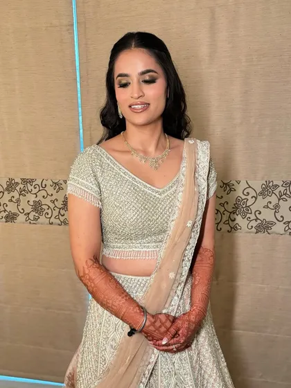 Manpreet's engagement look. A classic soft smokey eye with voluminous curls for a timelessly beautiful result.