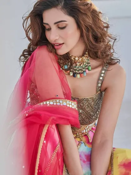For a vibrant sangeet or mehendi, a pop of color can be stunning. Here, I created a soft glam look with a flawless base that complements the bride's colorful lehenga. The makeup is designed to be bright and joyful while still looking polished and elegant.