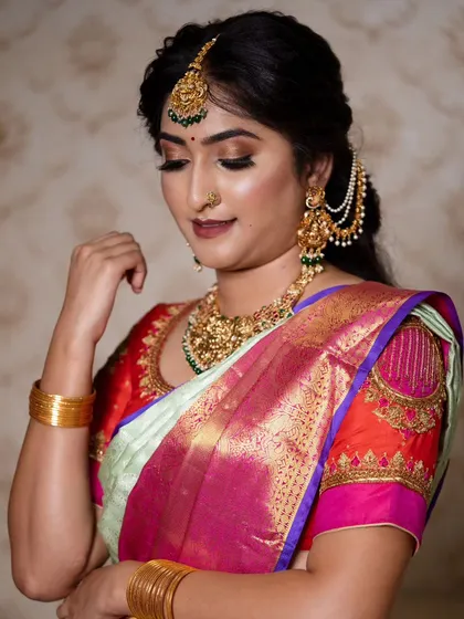 This close-up shows the details I love: a soft, shimmery eyeshadow to make the eyes pop, perfectly blended skin, and traditional jewelry that completes the look. It's all about that signature glow.