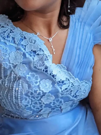 A closer look at the sky blue party wear gown. The design features delicate lace, beading, and a pleated shoulder detail for a unique touch.