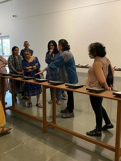 Artist Pushpamala N. leading a walkthrough of the 'Quieter than Silence' exhibition. Peer-led tours offer unique and insightful perspectives on the work.