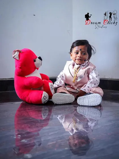 A sweet moment between a baby boy and his teddy bear. Using simple props like a stuffed animal can help little ones feel comfortable and bring out their gentle side during a shoot.