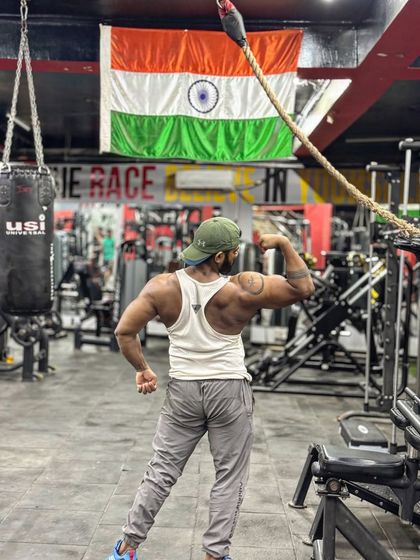 A back view of my 16-inch bicep pose. A strong back and arms are the foundation of a powerful physique.