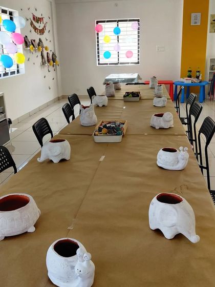 The calm before the creative storm! Animal planters are lined up, waiting for a group of excited kids to paint them.