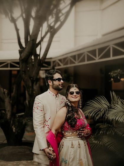 Cool, calm, and collected. The couple dons sunglasses for a stylish portrait, showing off their fun side while still looking effortlessly elegant in their traditional attire.