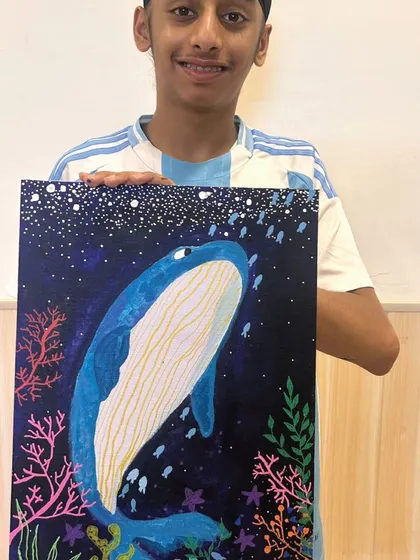 Look at the incredible detail and pride on this young artist's face. This stunning whale canvas is a perfect example of how I guide students to create artwork they can be truly proud of.