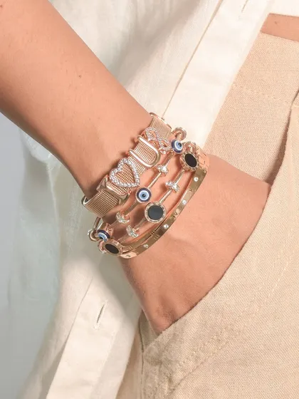 Build your own stack. This look features my popular 'BOSS' charm bangle layered with evil eye and studded cuffs for a powerful, statement-making look.