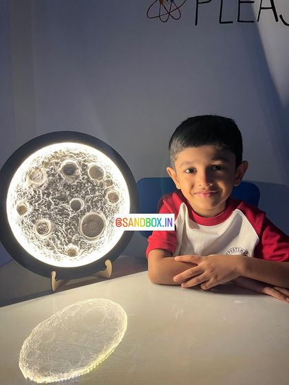 This young man is so pleased with his handcrafted moon lamp, and he should be! The kit comes with everything you need to create this textured, glowing piece of art for your room.