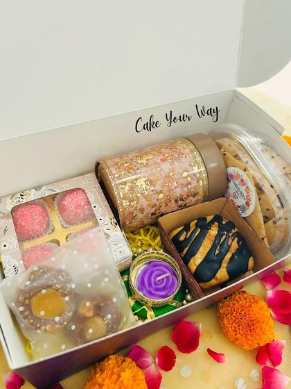 A beautifully packed "Khushiyon Ki Diwali" Box, with all the treats nestled inside, ready to be gifted. The included diya adds a festive touch.
