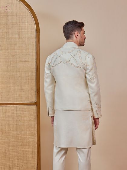 The back view of the cream shacket, showing how the delicate embroidery continues, ensuring the garment is beautifully finished from every angle.