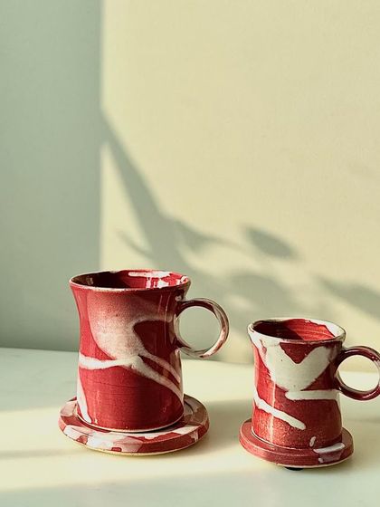 The Flamingo series cups and mugs with matching coasters. The bright, energetic glaze is perfect for adding a pop of color to your day.