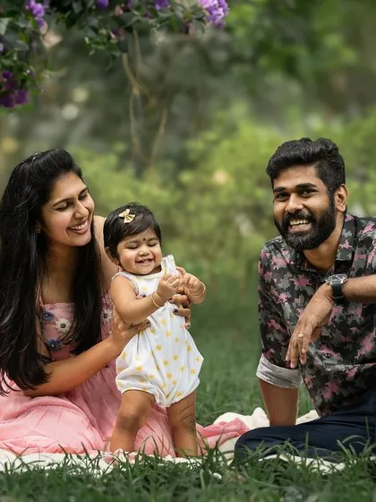A relaxed family portrait taken outdoors in a beautiful park. Natural light and a comfortable setting allow for genuine smiles and connections, creating warm and authentic memories.