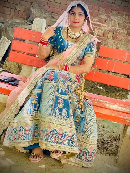 A happy client posing in the popular Doli Barat lehenga. This shows how the outfit looks in a real-world outdoor setting.