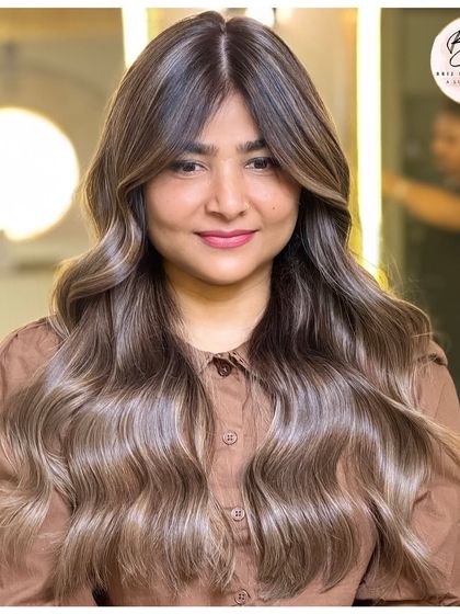 From roots to tips, every strand of this ash blonde balayage tells a story of bold, bright, and beautiful color.