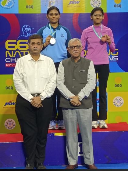 Divya TS on the podium after winning the silver medal in the 50M Free Pistol Senior National Category at the 66th National Shooting Competition.