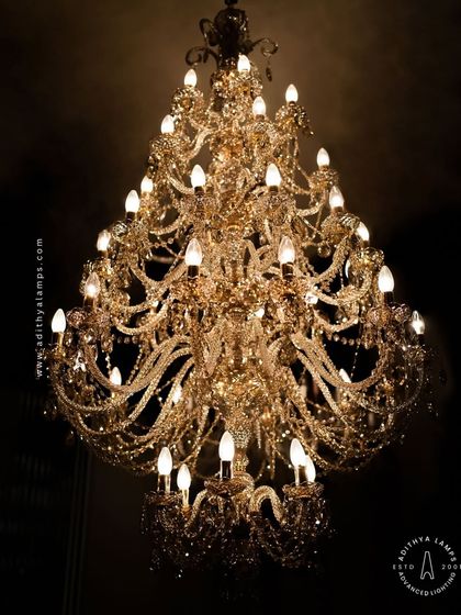 A detailed look at our magnificent multi-tiered crystal chandelier. Each arm is draped with shimmering crystal beads that reflect and refract light, creating an unparalleled sparkle. This fixture is a testament to classic European design and meticulous craftsmanship.