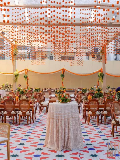 Another perspective of the dining area, focusing on the cocktail tables and the expansive feel of the space under the floral canopy.