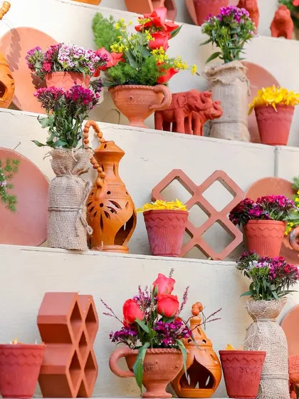 A closer look at the variety of terracotta artifacts and small floral arrangements on the tiered display shelf. Each piece was carefully selected and placed.