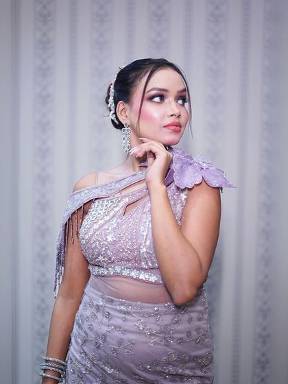 A beautiful close-up that captures the soft makeup and the unique texture of the gown.