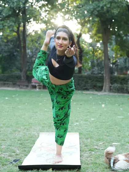Practicing Natarajasana, the Lord of the Dance pose, in a beautiful park. This asana is wonderful for building strength, balance, and flexibility, helping to open the hips and focus the mind.