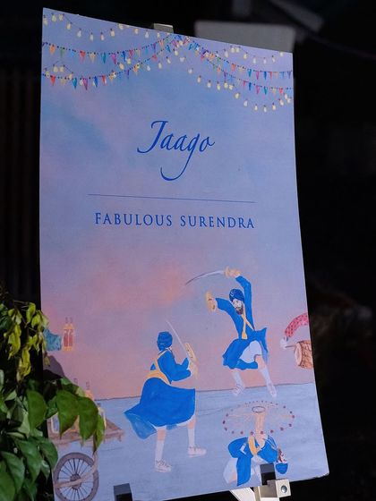 The beautifully illustrated welcome sign for the "Fabulous Surendra" Jaago night. The artwork depicts traditional Gatka performers, setting the tone for a culturally rich and festive celebration.