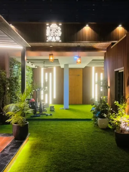 A completed terrace project in Model Town, New Delhi, showing a long walkway leading to a pergola-covered gym area.