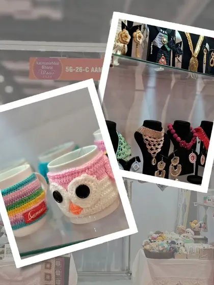 Our stall display featuring owl-themed crochet mug cozies and a variety of jewellery. The mug cozies are a fun and practical way to add personality to your kitchen.
