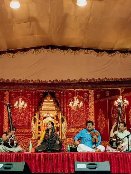 A full view of the stage at Sree Ramaseva Mandali. The traditional backdrop and the attentive audience create a perfect setting for a pure classical music experience.