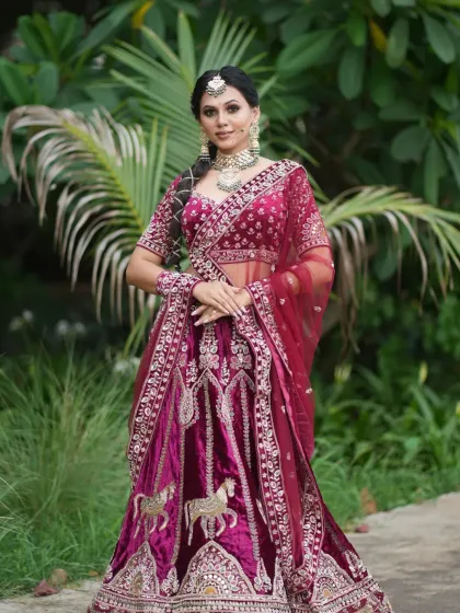 The full grandeur of the traditional bridal lehenga, complete with horse motifs, is on display here.