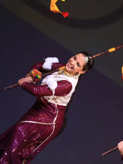 A dynamic action shot of a Bhangra performer mid-twirl, capturing the vibrant energy of their folk dance.