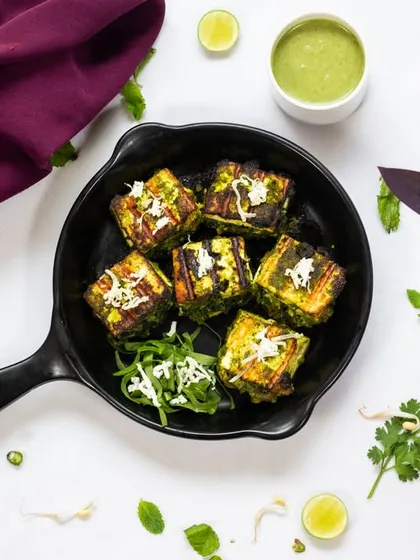 Hariyali Tawa Paneer Tikka, cooked on a griddle for a perfect char. The mint and coriander marinade gives it a fresh and vibrant flavor.