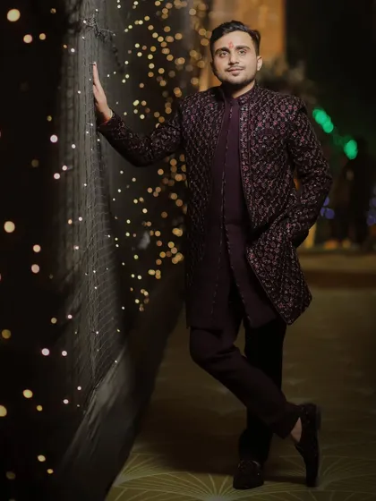 A stylish full-length portrait of the groom against a wall of lights. We know how to use the decor to create dynamic and interesting shots for our grooms.