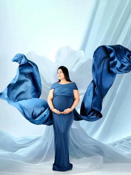 A powerful and artistic shot using flowing blue fabric to create the shape of wings. This is a creative technique I use to add drama and movement to your portraits.