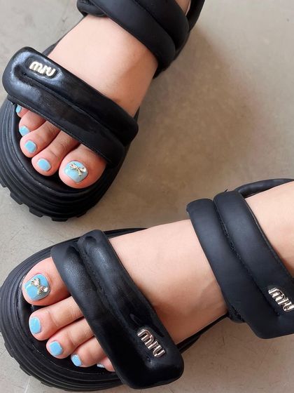 Your new obsession: a cute pedicure with baby blue polish and a sparkling 3D bow and rhinestone accent on the big toe.