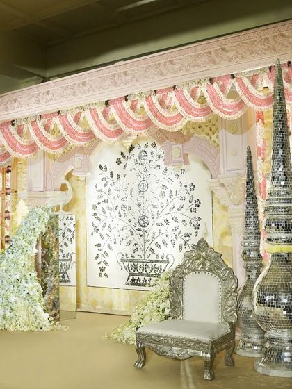 For this ring ceremony puja, I designed an elegant indoor space with soothing pastel decor. The serene setting, featuring a beautiful tree-of-life backdrop and silver thrones, provided a perfect backdrop for the sacred rituals.