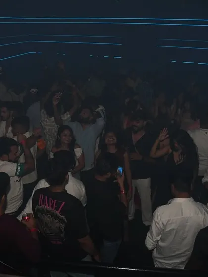 A wide shot of the packed dance floor at Loop Ranchi under cool blue lighting.