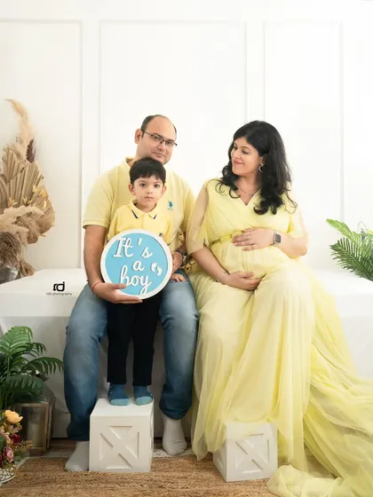 The family announces "It's a boy!" together. Including the older sibling in the gender reveal makes the moment even more special and memorable.