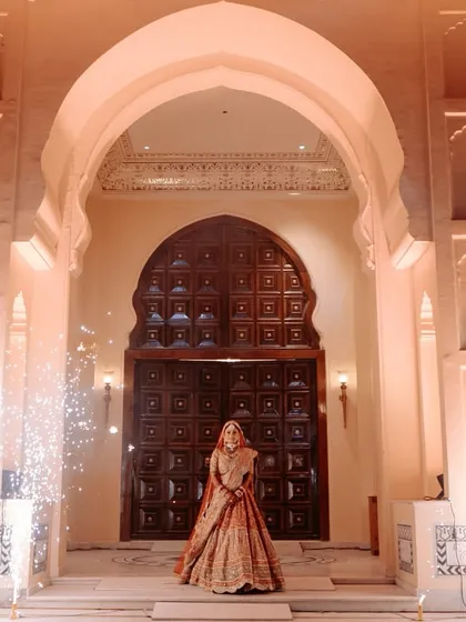 A bride's entry should be nothing short of majestic. We conceptualized this royal procession with a stunning architectural backdrop and perfectly timed cold pyros to create a truly regal and unforgettable varmala moment.