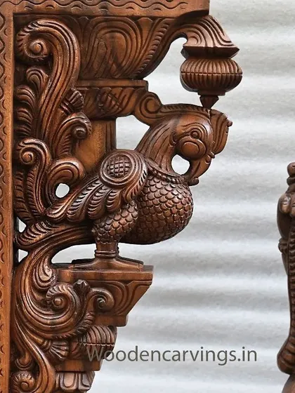 A close-up of the Annapakshi bracket from the Krishna set. The intricate carving of the bird's feathers and the delicate form of the kalasam (pot) it holds are clearly visible.