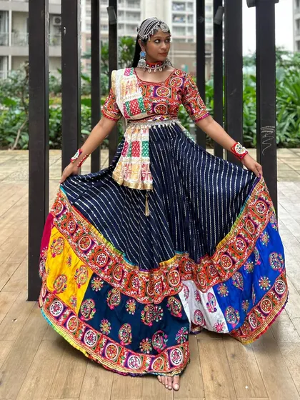 Spreading out the ghera to show the incredible detail and craftsmanship of this lehenga. Each panel tells its own story with different colors and patterns.