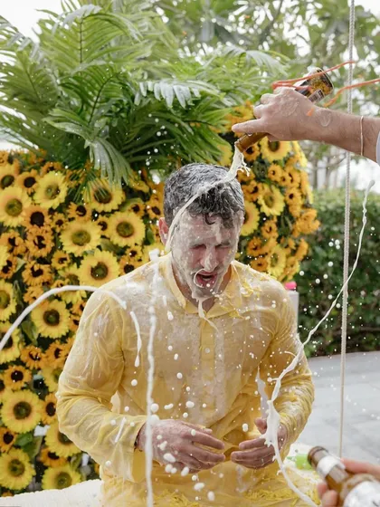 Shivaan gets a beer shower at his haldi, a fun and messy celebration with friends. These moments of wild fun are a huge part of the wedding story.