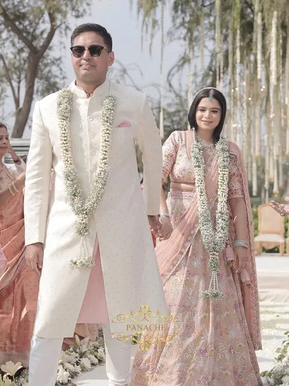 The couple walks down the aisle together after the ceremony, a picture of elegance and happiness.