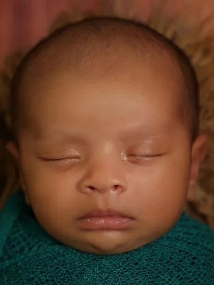 A detailed close-up of a sleeping newborn's face. These simple shots are perfect for capturing the delicate, serene features of your baby in their first few weeks.