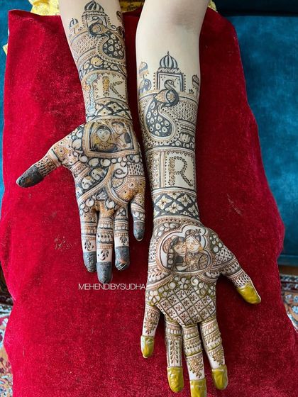 Here, I've hidden the couple's initials, 'R' and 'K', within the intricate design. The palms feature custom portraits from their engagement, making this a truly bespoke bridal mehendi.