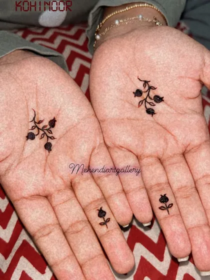A closer look at the minimalist floral sprig designs on the palms and fingers.