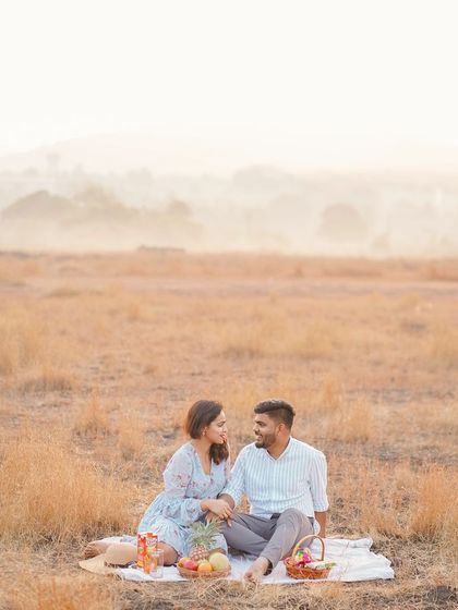 A romantic picnic-themed shoot in a golden field at sunset. This is a great example of a relaxed, themed shoot that uses the beauty of natural light.