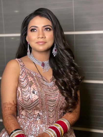 A beautiful princess look for a reception. The hair is styled in soft, open waves, keeping the look glamorous and comfortable for a night of celebration.