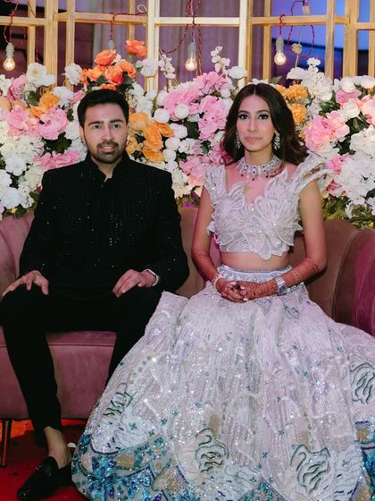 The couple seated on their stage, looking regal and happy.