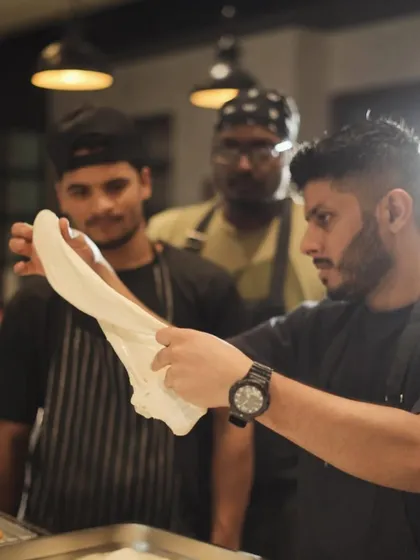 Here I am teaching my team the art of stretching pizza dough. Sharing knowledge and passion with my crew is one of the most rewarding parts of being a chef.